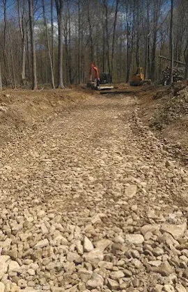 Landmark Enterprises excavation and gravel driveway grading in Dewittville, NY with excavators on the finished road